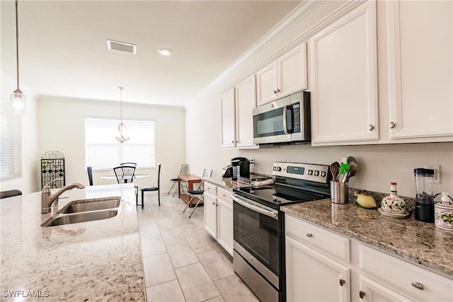 kitchen with pendant lighting, sink, white cabinetry, and stainless steel appliances