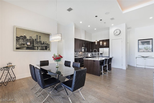 dining room with hardwood / wood-style flooring and sink