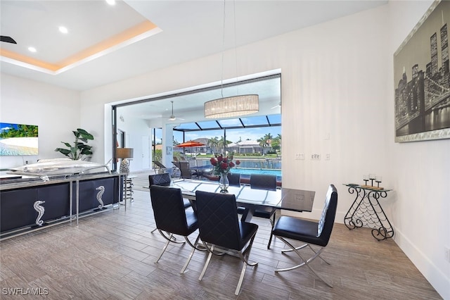 dining space with a raised ceiling