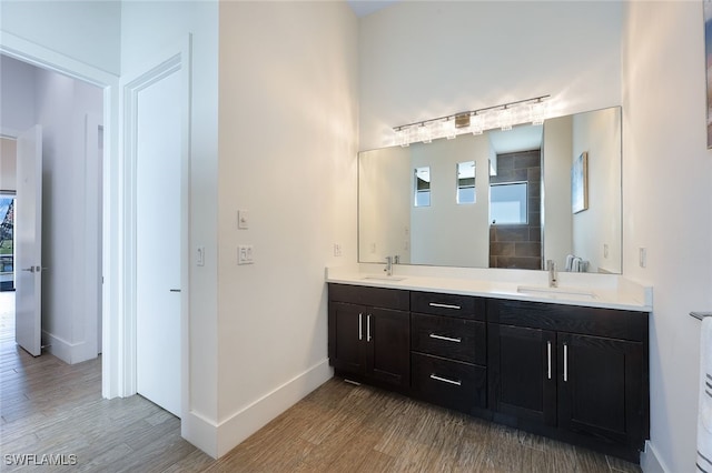 bathroom with a shower, wood-type flooring, and vanity