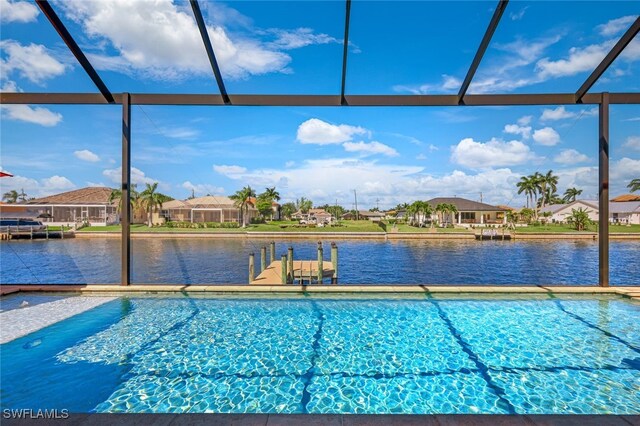 view of swimming pool with a lanai and a water view