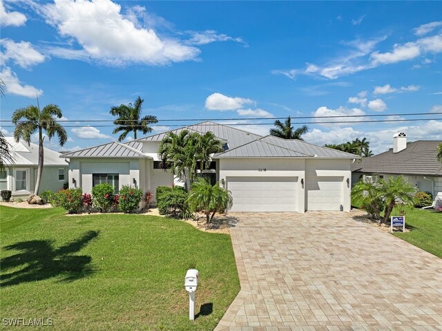 view of front of property with a garage and a front lawn