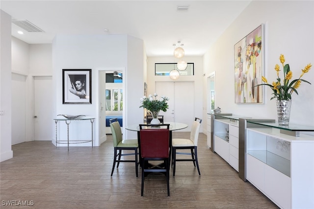 dining space with hardwood / wood-style flooring