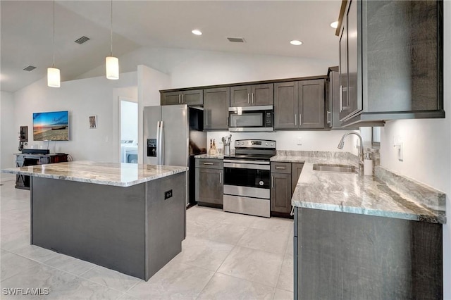 kitchen featuring pendant lighting, a center island, lofted ceiling, sink, and stainless steel appliances