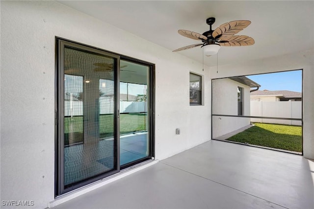 unfurnished sunroom featuring ceiling fan