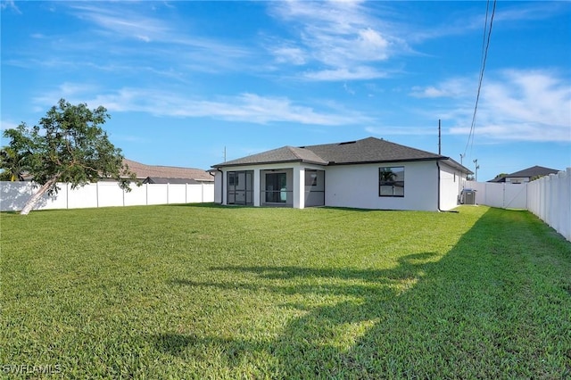 back of house with a lawn