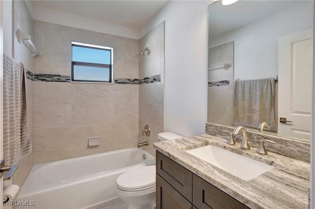 full bathroom with vanity, toilet, and tiled shower / bath