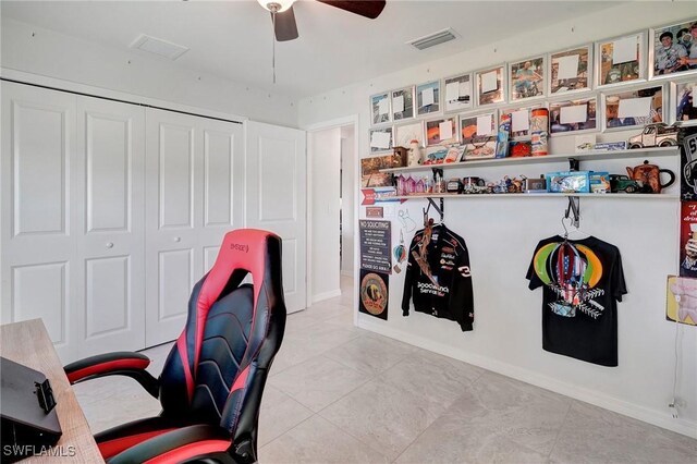 tiled office space featuring ceiling fan