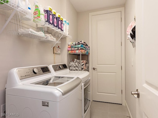 washroom with light tile patterned floors and separate washer and dryer