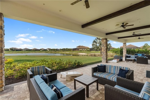 view of patio / terrace featuring an outdoor living space, a water view, and ceiling fan