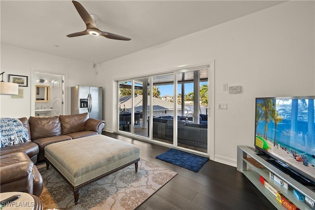 living room with ceiling fan and dark hardwood / wood-style floors