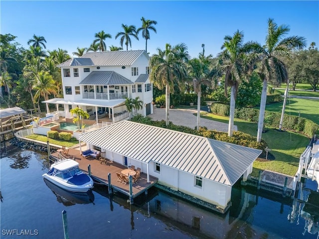 rear view of property with a water view