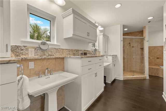 bathroom featuring wood-type flooring and a shower with door