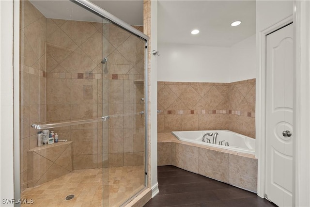 bathroom featuring plus walk in shower and hardwood / wood-style floors