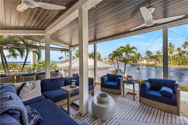 exterior space featuring a water view, ceiling fan, and an outdoor hangout area