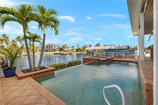 view of pool with an in ground hot tub and a water view