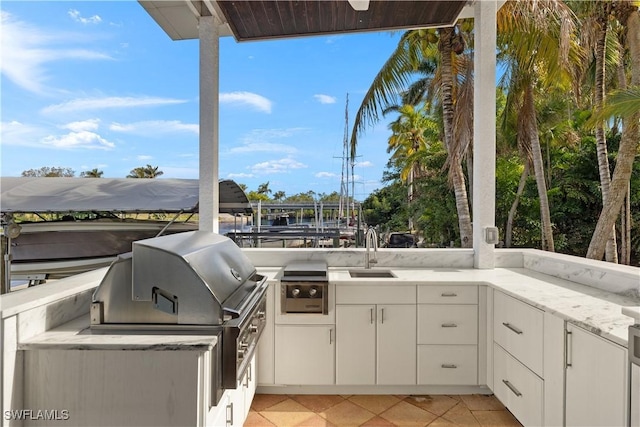 view of patio / terrace featuring area for grilling, sink, and exterior kitchen