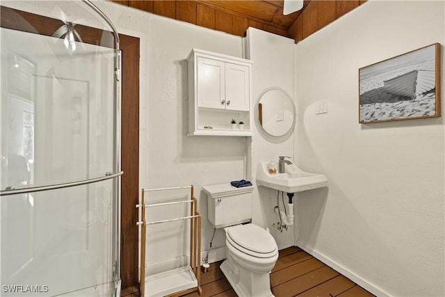 bathroom featuring hardwood / wood-style flooring and toilet