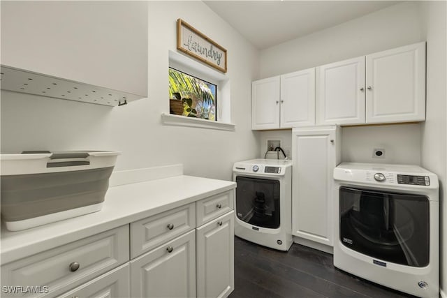 washroom with cabinets, dark hardwood / wood-style floors, and washing machine and dryer