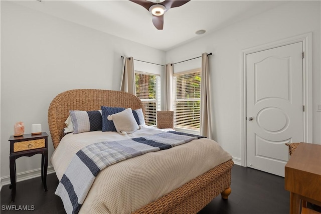 bedroom with dark hardwood / wood-style floors and ceiling fan