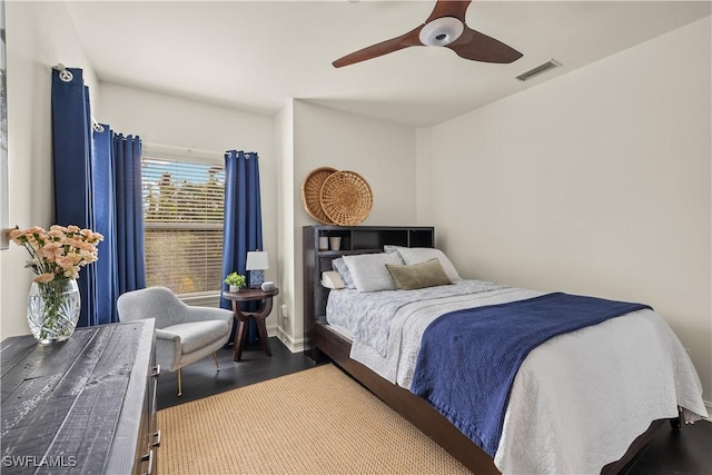 bedroom with dark hardwood / wood-style floors and ceiling fan