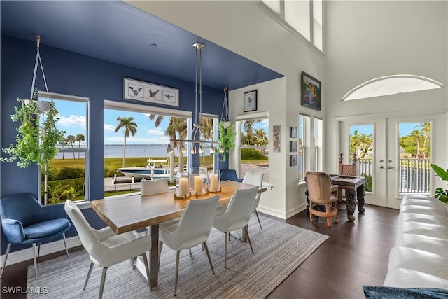 sunroom with a water view and french doors