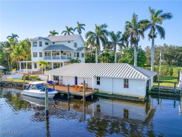 rear view of house featuring a water view