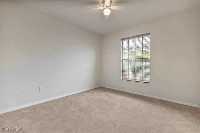 carpeted empty room featuring ceiling fan