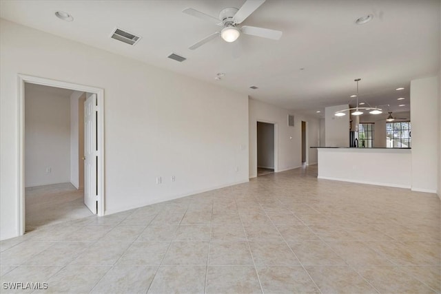 unfurnished living room with ceiling fan and light tile patterned floors