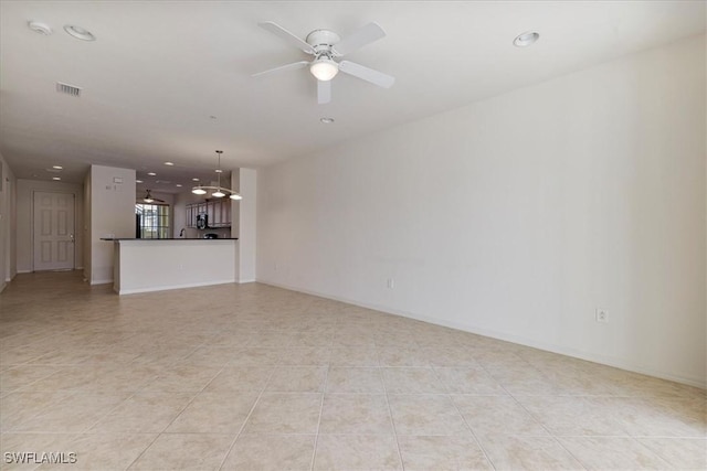 unfurnished living room featuring ceiling fan and light tile patterned floors