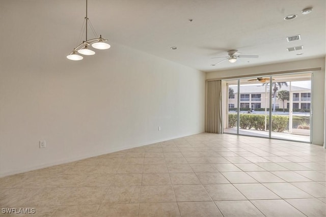 tiled spare room with ceiling fan