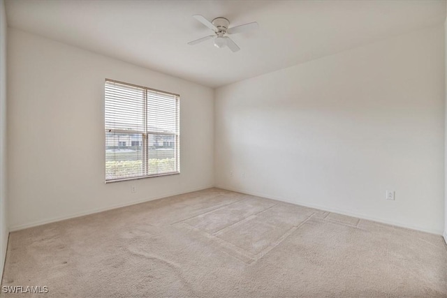 unfurnished room featuring ceiling fan and light carpet