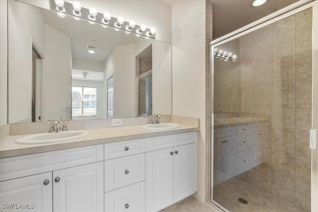 bathroom featuring vanity, walk in shower, and ceiling fan