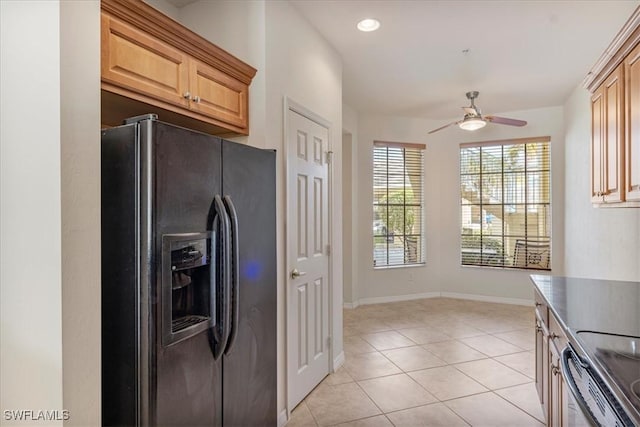 kitchen featuring ceiling fan, light brown cabinets, refrigerator with ice dispenser, light tile patterned flooring, and range