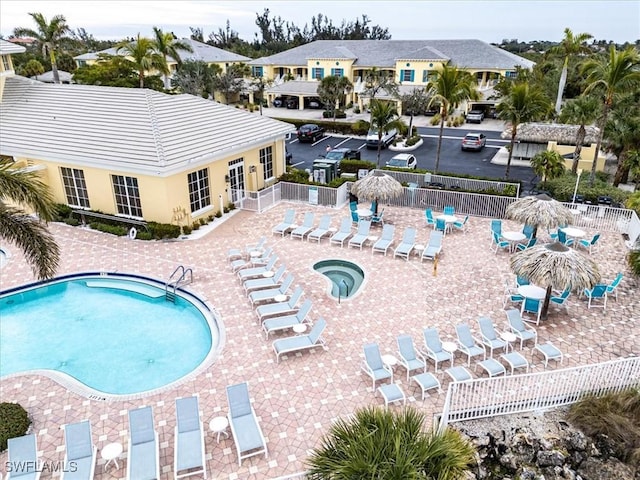 view of pool with a community hot tub and a patio