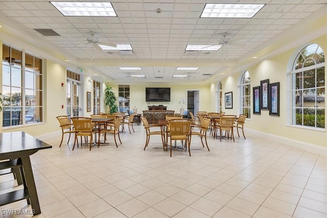 dining area featuring light tile patterned floors, a paneled ceiling, and ceiling fan