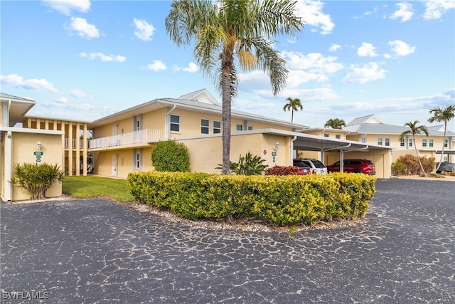 view of front of home with a carport