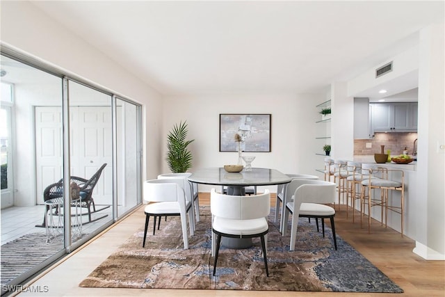 dining space with light hardwood / wood-style floors