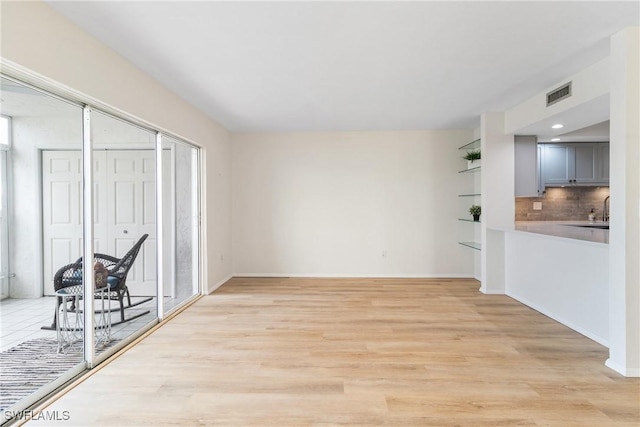 interior space featuring sink and light hardwood / wood-style floors