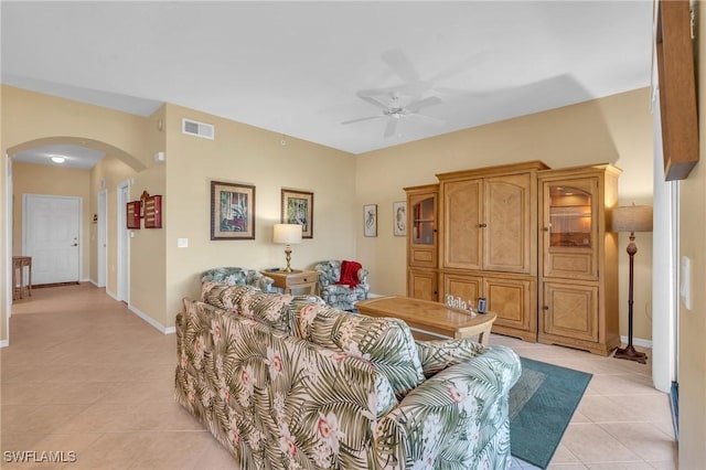 tiled living room featuring ceiling fan