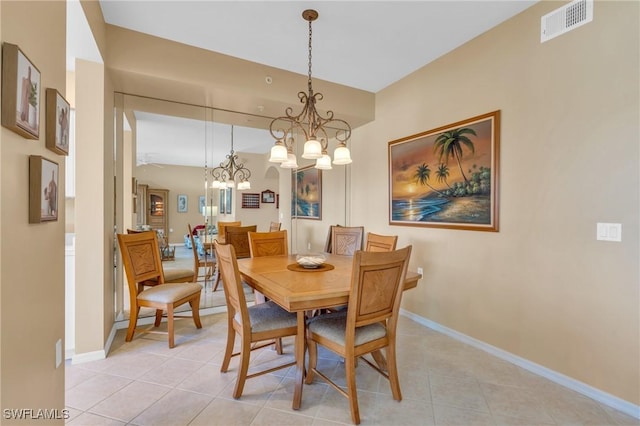 tiled dining area with a notable chandelier