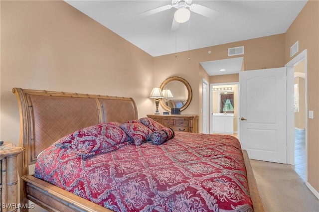 bedroom with light carpet, connected bathroom, and ceiling fan