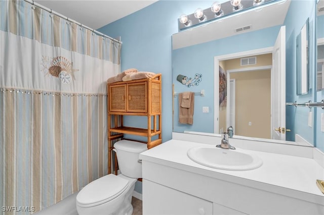 bathroom featuring a shower with curtain, vanity, and toilet