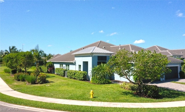 exterior space with a garage and a front lawn