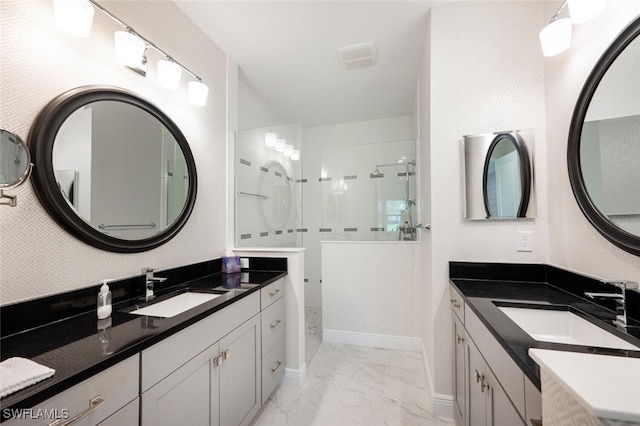 bathroom featuring a tile shower and vanity