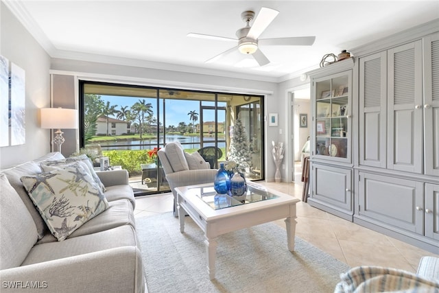 living room featuring ceiling fan, crown molding, a water view, and light tile patterned floors