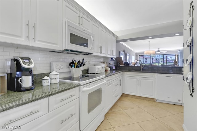 kitchen with backsplash, white cabinetry, white appliances, and sink