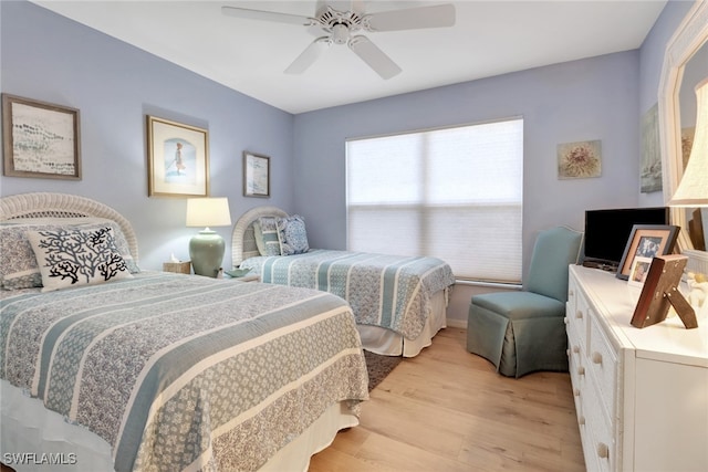 bedroom with ceiling fan and light hardwood / wood-style flooring