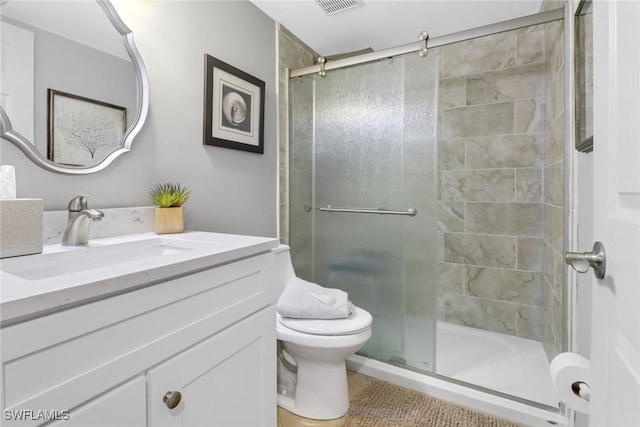 bathroom featuring walk in shower, vanity, and toilet