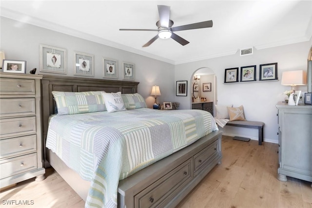 bedroom featuring ceiling fan, crown molding, and light hardwood / wood-style floors